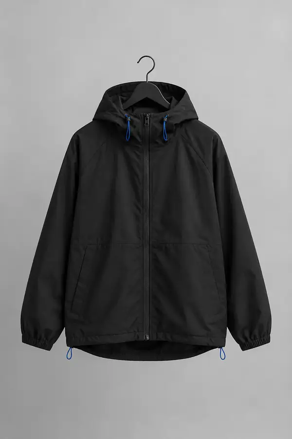 Plain black hooded jacket on a hanger against a light grey backdrop